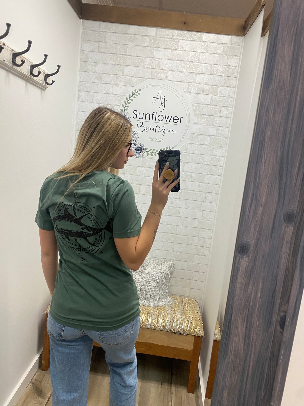 Woman wearing a t-shirt with a Long Island Tuna graphic on the back.