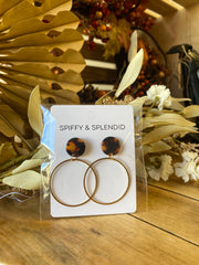 Pair of round earrings with tortoiseshell and gold design on a 'Spiffy & Splendid' card, surrounded by decorative elements.