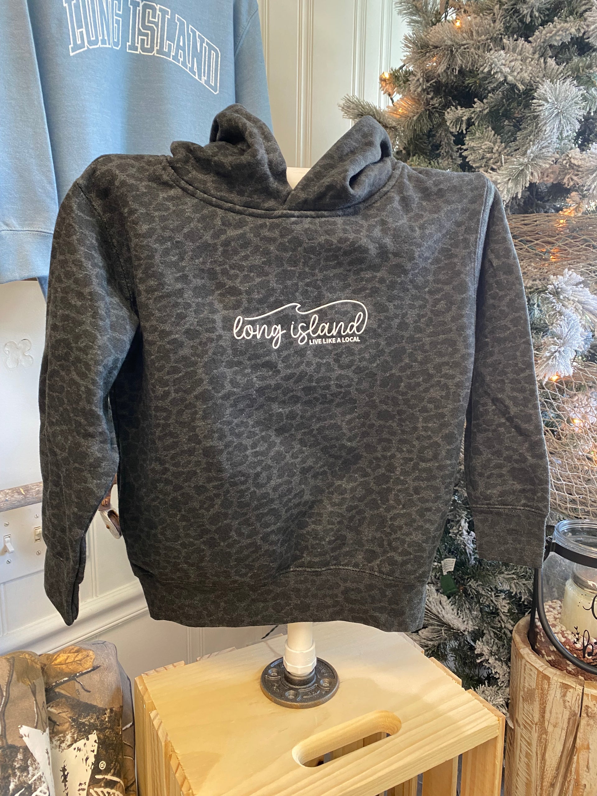 An animal print sweatshirt with a logo on display in a store