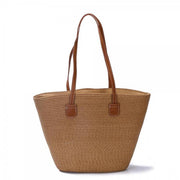 Woven straw tote bag with brown faux leather shoulder straps and structured shape