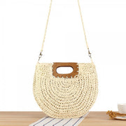 Round woven straw crossbody bag with wooden top handle and long strap