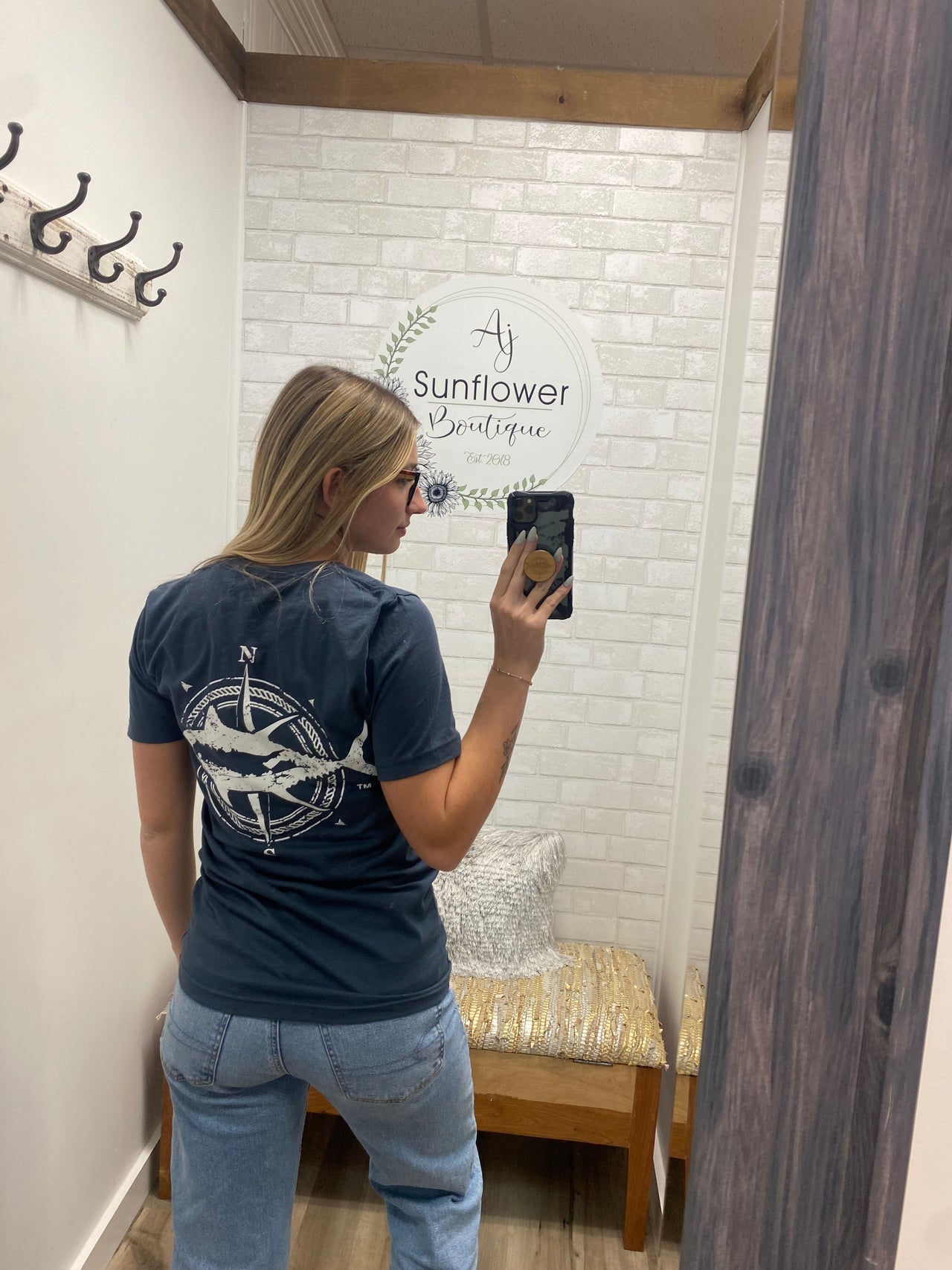 woman wearing a t-shirt with a Long Island Tuna  graphic on the back.